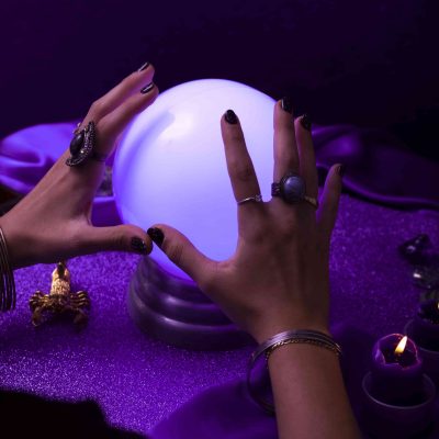 high-angle-hands-holding-crystal-ball (1)-min